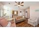 Cozy living room featuring wood floors, comfortable seating, and an open view into the dining area and kitchen at 117 Blue Bonnet St, Summerville, SC 29483