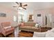 Cozy living room featuring wood floors, comfortable seating, and an open view into the dining area and kitchen at 117 Blue Bonnet St, Summerville, SC 29483