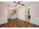 Open-concept living room featuring wood floors, ceiling fan, staircase and view into the kitchen at 117 Blue Bonnet St, Summerville, SC 29483