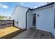 Backyard features a wooden deck, white siding, and well-maintained fencing, offering a private oasis for outdoor enjoyment and relaxation at 119 Summer Tanager Dr, Ravenel, SC 29470