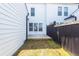 A backyard featuring a wooden deck, dark fencing, and white siding, creating a serene and inviting outdoor space for relaxation at 119 Summer Tanager Dr, Ravenel, SC 29470
