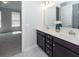 Bathroom with dual sinks, a white countertop, and an adjoining bedroom at 119 Summer Tanager Dr, Ravenel, SC 29470
