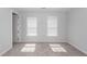 Bright bedroom with neutral carpet, two windows, and white trim at 119 Summer Tanager Dr, Ravenel, SC 29470