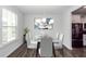 Stylish dining room featuring a modern chandelier and a glass-top table with seating for six at 119 Summer Tanager Dr, Ravenel, SC 29470