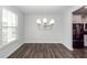 Bright dining area with hardwood floors and a view of the modern kitchen at 119 Summer Tanager Dr, Ravenel, SC 29470