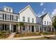 Beautifully landscaped exterior showing a two-story home with a welcoming front porch at 119 Summer Tanager Dr, Ravenel, SC 29470