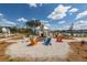 Relax by the community fire pit with colorful Adirondack chairs and a charming white building in the background at 119 Summer Tanager Dr, Ravenel, SC 29470