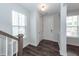 Bright foyer with hardwood floors, closet, and a staircase leading to the upper level at 119 Summer Tanager Dr, Ravenel, SC 29470