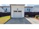 Exterior view of detached one-car garage with carriage door and concrete driveway at 119 Summer Tanager Dr, Ravenel, SC 29470