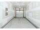 Spacious two-car garage with white walls, concrete floor and white garage door at 119 Summer Tanager Dr, Ravenel, SC 29470