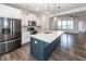 Bright kitchen boasts stainless appliances, island with sink and quartz countertop at 119 Summer Tanager Dr, Ravenel, SC 29470