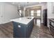 Open kitchen features a spacious island with bar seating and stainless steel appliances at 119 Summer Tanager Dr, Ravenel, SC 29470