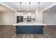 Kitchen island with a white countertop and a deep blue base with stainless steel appliances at 119 Summer Tanager Dr, Ravenel, SC 29470