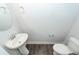 Compact powder room featuring a pedestal sink, toilet, and modern fixtures at 119 Summer Tanager Dr, Ravenel, SC 29470