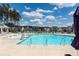 Community swimming pool featuring zero entry, lounge chairs, and community homes in the background at 119 Summer Tanager Dr, Ravenel, SC 29470