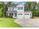 Charming two-story home featuring a two-car garage and a well-manicured lawn with mature trees at 120 Mcmakin Dr # 16, Summerville, SC 29483