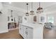 Stylish kitchen featuring a marble island, white cabinetry, and an open-concept design flowing into the dining area at 120 Mcmakin Dr # 16, Summerville, SC 29483