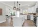 Modern kitchen with white cabinets, stainless steel appliances, and a view into the living area at 120 Mcmakin Dr # 16, Summerville, SC 29483