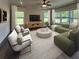 Spacious living room with comfortable seating, a ceiling fan, large windows, and neutral decor at 120 Mcmakin Dr # 16, Summerville, SC 29483