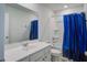 Clean bathroom with vanity, toilet, and tub/shower combo with blue curtain at 124 Sumac Dr, Goose Creek, SC 29445
