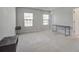 Spacious bedroom with two windows, carpet flooring and accent floating shelves at 124 Sumac Dr, Goose Creek, SC 29445