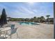 Community pool with plenty of lounge seating, palm trees, and well-maintained grounds at 124 Sumac Dr, Goose Creek, SC 29445