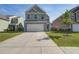 Charming two-story home with attached garage and well-manicured lawn at 124 Sumac Dr, Goose Creek, SC 29445