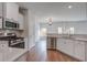 Modern kitchen featuring stainless steel appliances, quartz countertops, and a view into living area at 124 Sumac Dr, Goose Creek, SC 29445