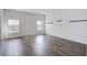 Bright living room featuring hardwood floors, two windows, and ample natural light at 124 Sumac Dr, Goose Creek, SC 29445
