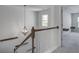 Staircase with modern light fixture and wooden handrail at 124 Sumac Dr, Goose Creek, SC 29445
