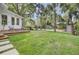 Spacious backyard featuring a patio, deck, fire pit, lounge chairs, and lush green lawn at 126 Sparrow Dr, Isle of Palms, SC 29451