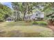 Beautiful backyard with a pool, outdoor lounge area, mature trees, and lush green lawn at 126 Sparrow Dr, Isle of Palms, SC 29451