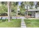 Inviting backyard with a pool, stone pathway, and a stylish cabana featuring swing seating at 126 Sparrow Dr, Isle of Palms, SC 29451