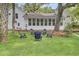 Backyard with a fire pit area, surrounded by chairs, a well-maintained lawn, and a beautiful home exterior at 126 Sparrow Dr, Isle of Palms, SC 29451