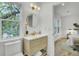Bathroom featuring vanity, sink, commode, and a view out the window at 126 Sparrow Dr, Isle of Palms, SC 29451