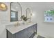 Bathroom with double sink vanity, framed mirrors and marble countertop at 126 Sparrow Dr, Isle of Palms, SC 29451