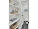 Charming bathroom with open shelving, decorative baskets, and unique patterned tile flooring at 126 Sparrow Dr, Isle of Palms, SC 29451