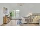 Bright bedroom with wood floors, a decorative chandelier, and a large window at 126 Sparrow Dr, Isle of Palms, SC 29451