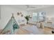 Bright bedroom with decoratively styled teepee, crib, and chair with accent rug at 126 Sparrow Dr, Isle of Palms, SC 29451