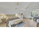 Spacious bedroom with wood floors and a decorative chandelier at 126 Sparrow Dr, Isle of Palms, SC 29451