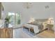 Bright bedroom with wood floors, a decorative chandelier, and a large window at 126 Sparrow Dr, Isle of Palms, SC 29451
