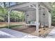 Stylish cabana with swing seating, wood floors, and ample space for outdoor relaxation at 126 Sparrow Dr, Isle of Palms, SC 29451