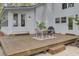 Outdoor deck with dining table, seating, and a grill, ideal for entertaining at 126 Sparrow Dr, Isle of Palms, SC 29451