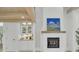 Living space with a cozy fireplace, built-in cabinets, and a striking blue painting above the mantel at 126 Sparrow Dr, Isle of Palms, SC 29451