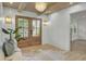 Elegant foyer with shiplap walls, wood-beamed ceiling, stylish lighting, and a welcoming bench at 126 Sparrow Dr, Isle of Palms, SC 29451