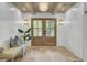 Elegant foyer with shiplap walls, wood-beamed ceiling, stylish lighting, and a welcoming bench at 126 Sparrow Dr, Isle of Palms, SC 29451