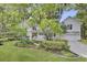 Beautiful white house featuring a lush green lawn, manicured landscaping, and a welcoming front porch at 126 Sparrow Dr, Isle of Palms, SC 29451