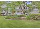 Charming two-story home with a lush green lawn, manicured landscaping, and a welcoming front porch at 126 Sparrow Dr, Isle of Palms, SC 29451