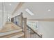Hallway with wood railing, black iron spindles, and overhead skylights at 126 Sparrow Dr, Isle of Palms, SC 29451
