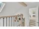 Hallway with wood railing, black iron spindles, and decorative wall hangings at 126 Sparrow Dr, Isle of Palms, SC 29451